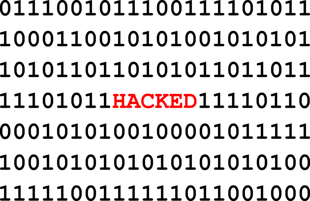 series of zeros and ones with the word HACKED in the center in red
