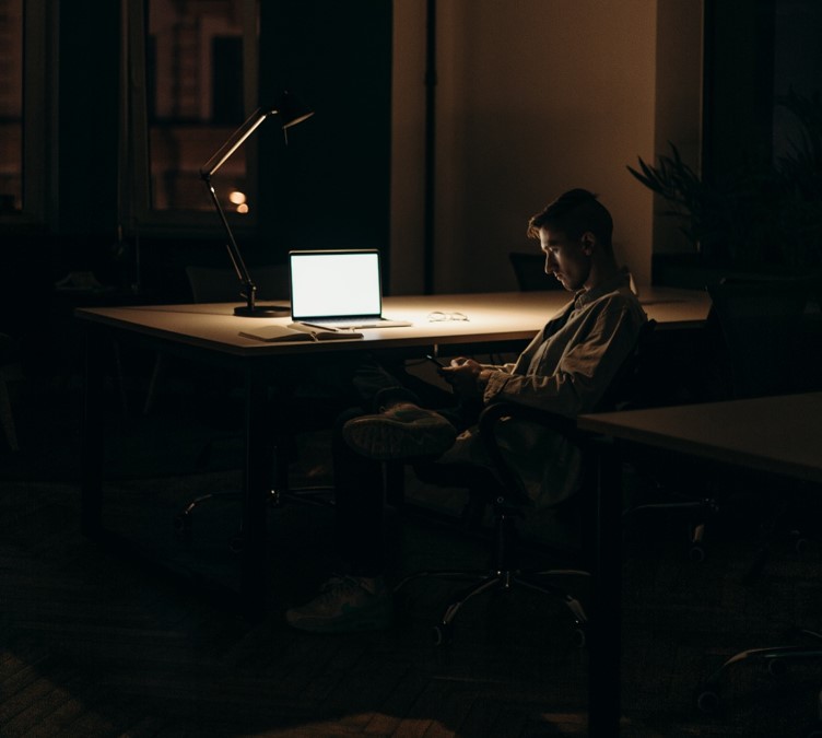 Man sitting in front of a computer late at night working