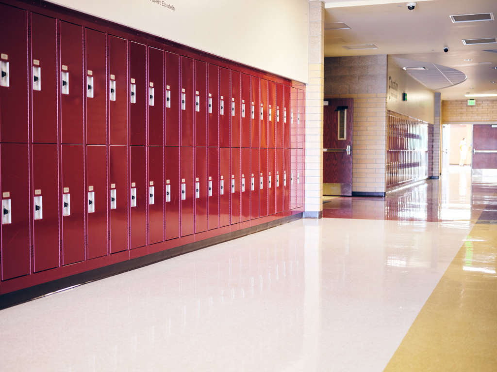 empty school hallway. Red lockers in background