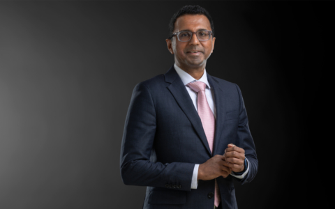 Professional photo of Vivek Swaminathan standing in front of a black gradient background
