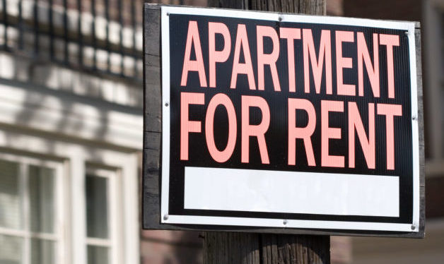 close-up of a rental sign in front an apartment building