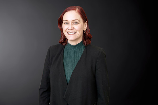 Professional photo of Christina Atkinson standing in front of a black gradient background