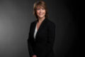 Professional photo of Cathy Guerra standing in front a black gradient background