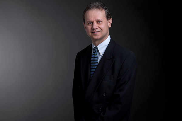 Professional photo of David Grebenc standing in front of a black gradient background