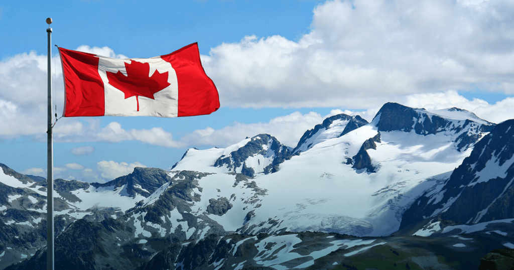 canada flag with rocky mountains in the background