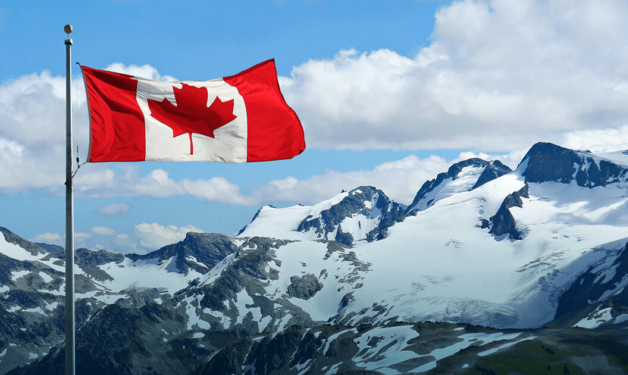 canada flag with rocky mountains in the background