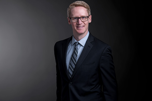 Professional photo of Darryl Teutenberg standing in front of a black gradient background