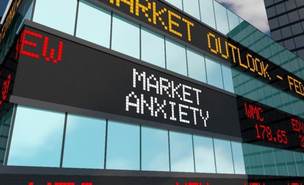 Corner of a glass building with the words "Market Anxiety" written on the side.
