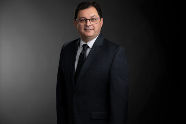 Professional photo of Wade Dempsey standing in front of a black gradient background