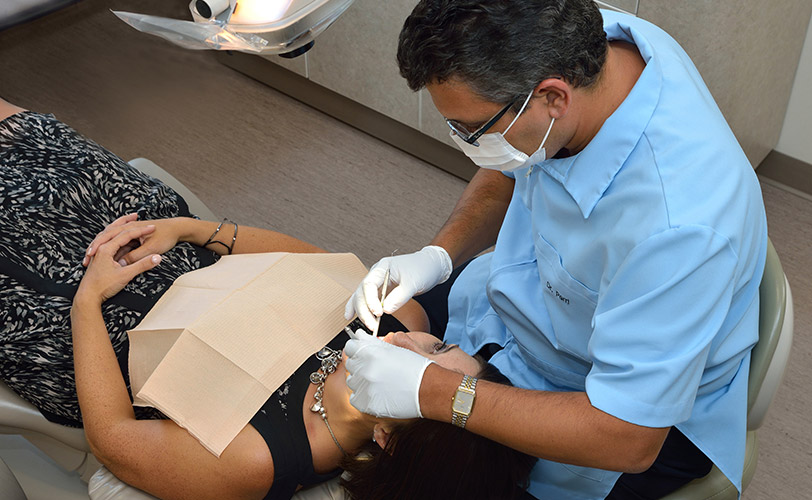 Dentist working on patient laying in chair