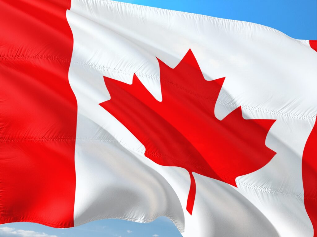 Canada flag waving, blue sky