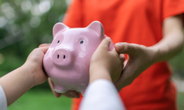 Mother handed the piggy bank to the child