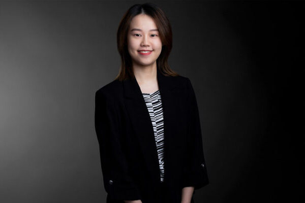 Professional photo of Siying (Amy) Wu standing in front of a black gradient background.