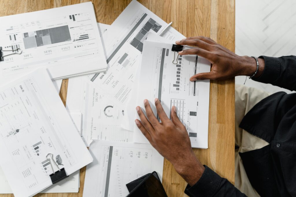 Close up of man's hands sorting through a bunch of paperwork