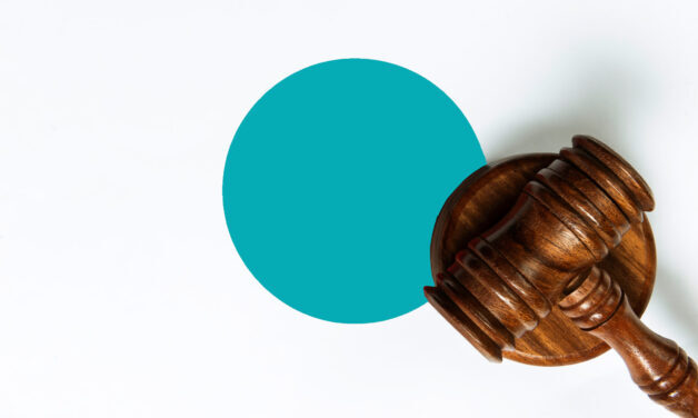 Brown gavel on a white background with a teal dot behind it.