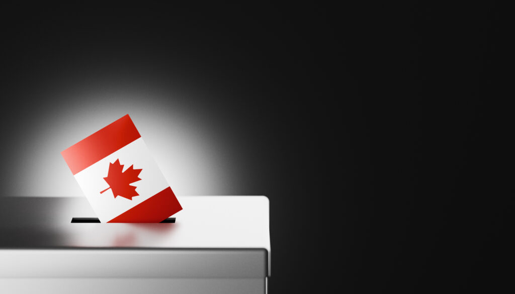 The Canadian flag, with its iconic red maple leaf on a white background, is shown being placed into a ballot box, symbolizing the democratic process and voter participation in Canada. This image captures themes of national identity, political responsibility, and civic duty, making it ideal for illustrating Canadian elections, government processes, and the importance of voting rights. Perfect for use in news articles, educational content, and social media posts related to Canadian democracy, elections, and civic engagement.