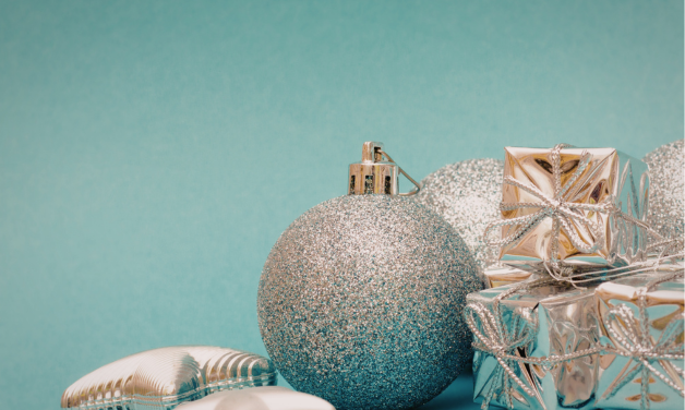 silver holiday ornament on teal background
