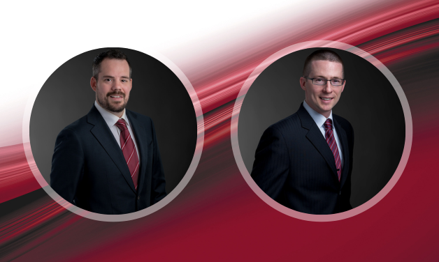 Professional photo of Matt Miedus and Shawn Rusan. A red ribbon is in the background.